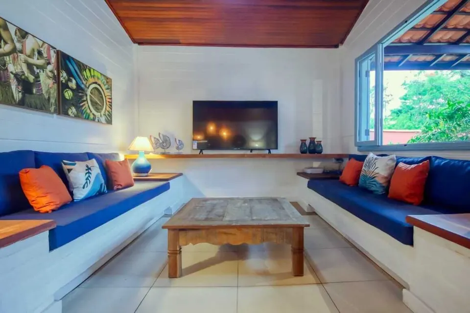 Bright living room with built-in sofas and television